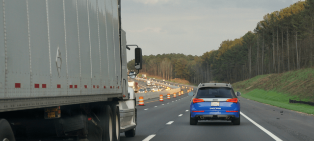 autonomous-driving-vehicle-next-to-semi-truck-comp Picture Box