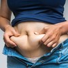a-woman-holding-her-belly-fat - Keto Prime