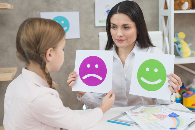 close-up-girl-choosing-sad-face-emoticons-paper-he Picture Box