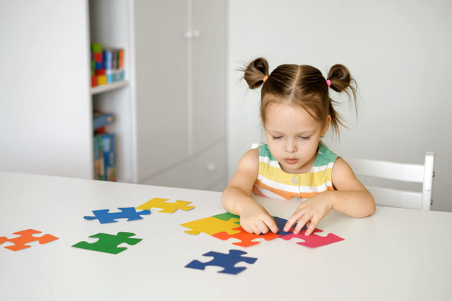 twoyearold-girl-collects-puzzles-sitting-table-nur Picture Box