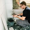 mason-working-on-a-bathroom... - Trinity Construction & Pain...