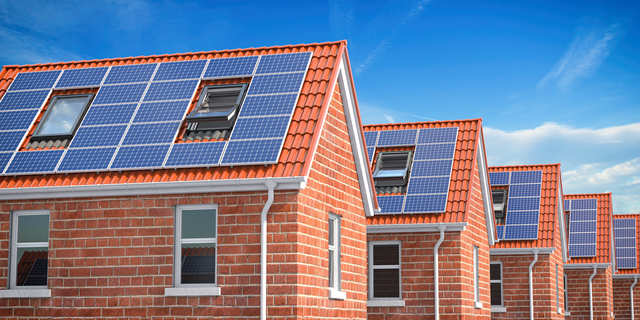 row-of-house-with-solar-panels-on-roof-on-blue-sk- DKZ-Solar GmbH