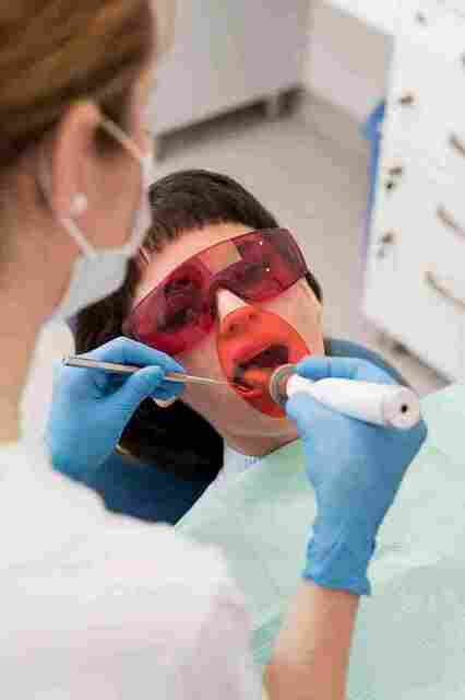 female-patient-having-procedure-done-dentist 11zon Picture Box