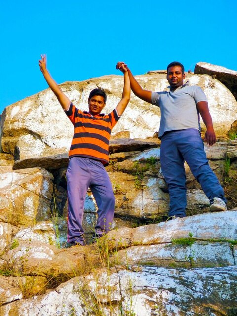 portrait-friends-with-arms-raised-standing-rocks-a Ooty Kodaikanal Tour Packages